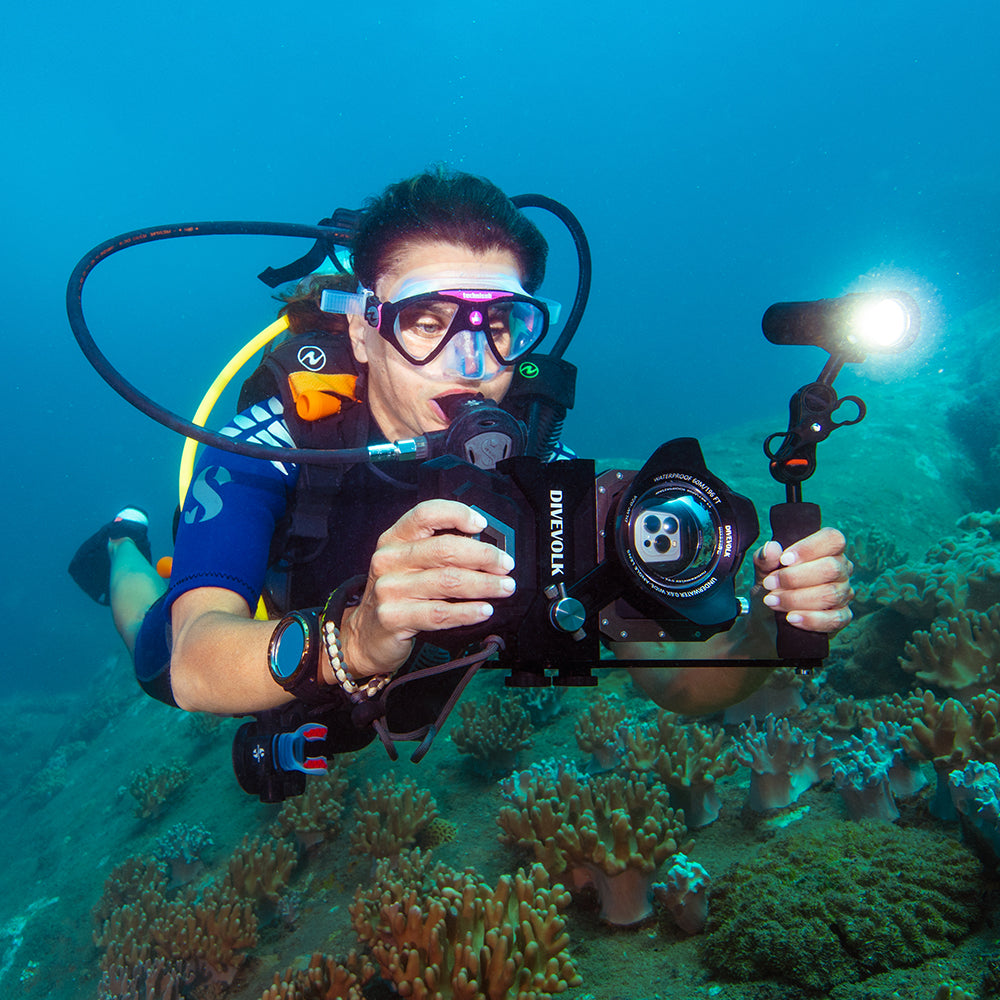 Diver using DiveVolk SeaTouch 4 Max underwater housing.