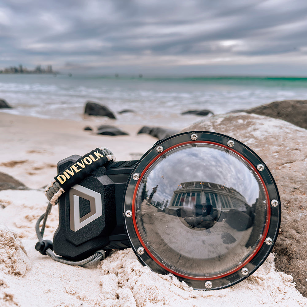 DiveVolk SeaTouch 4 Max underwater phone housing on beach sand.